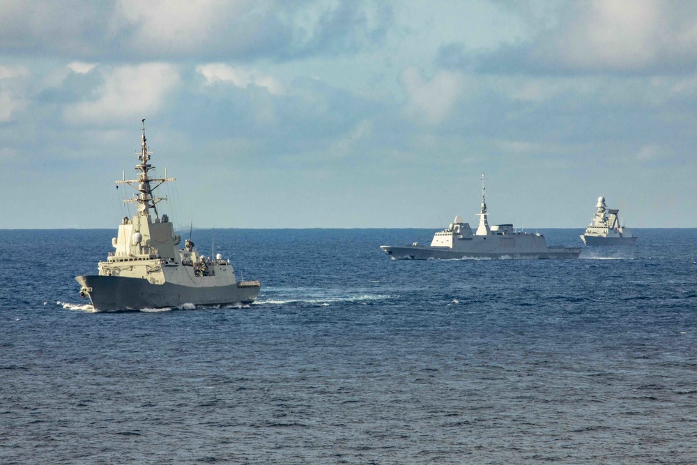 Multi-national ships in formation behind the Blue Ridge-class command and control ship USS Mount Whitney (LCC 20) during a photo exercise in the Atlantic Ocean