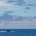 A P-8A Poseidon maritime patrol aircraft  flies over a Portuguese submarine
