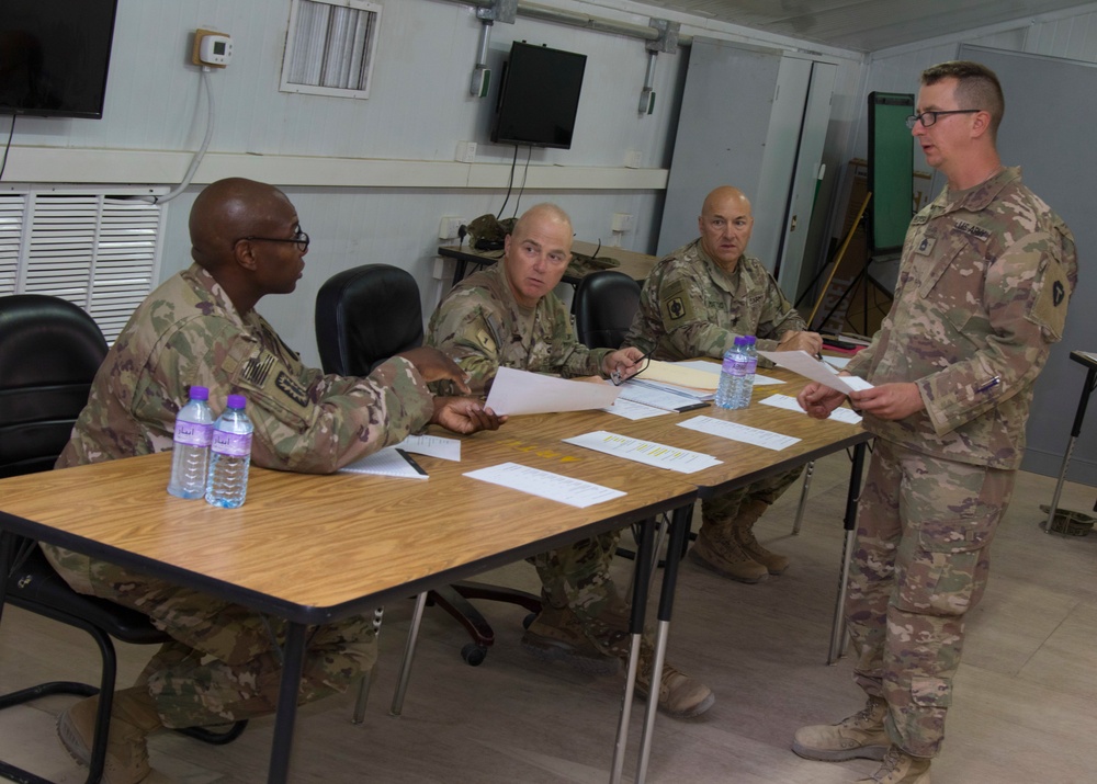 U.S. Army Command Sergeants Major with Task Force Avalanche, 130th Field Artillery Brigade, and Task Force Hellhound discuss scoring for board event during the TF Spartan Best Warrior Competition