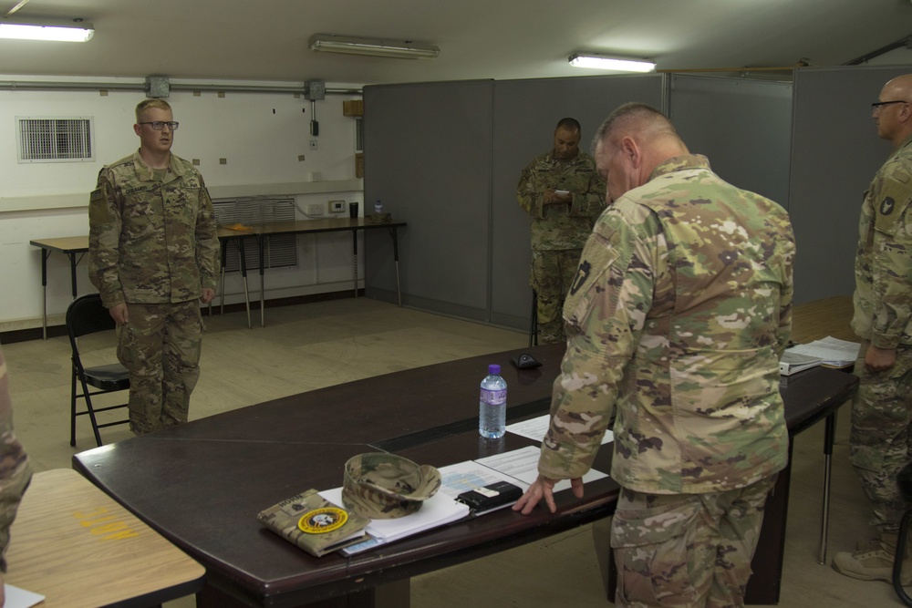Division Command Sgt. Maj. Jim Horn, Task Force Spartan command sergeant major, evaluates Soldiers during TF Spartan BWC Board event