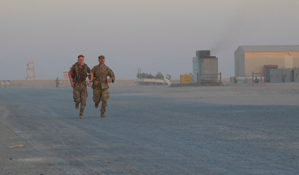 Task Force Hellhound Soldier sprints toward the finish line of 12-Mile Ruck March, Best Warrior Competition 2021