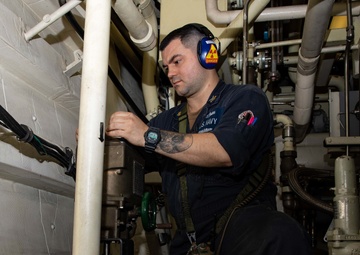 USS Sioux City Sailor Conducts Maintenance on Machinery