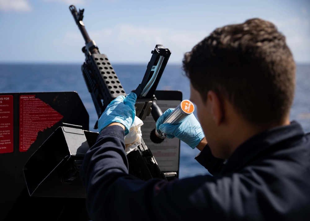 USS Sioux City Sailor Conducts Maintenance on M240B Machine Gun