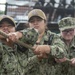 Sailors aboard USS Constitution heave lines to furl the ships Spanker Sail