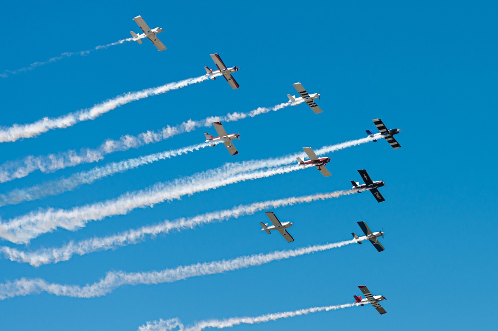 A formation of civilian single engine aircraft fly overhead during the Sound of Speed Airshow