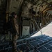 Loadmaster looks out the back end of a C-130 Hercules