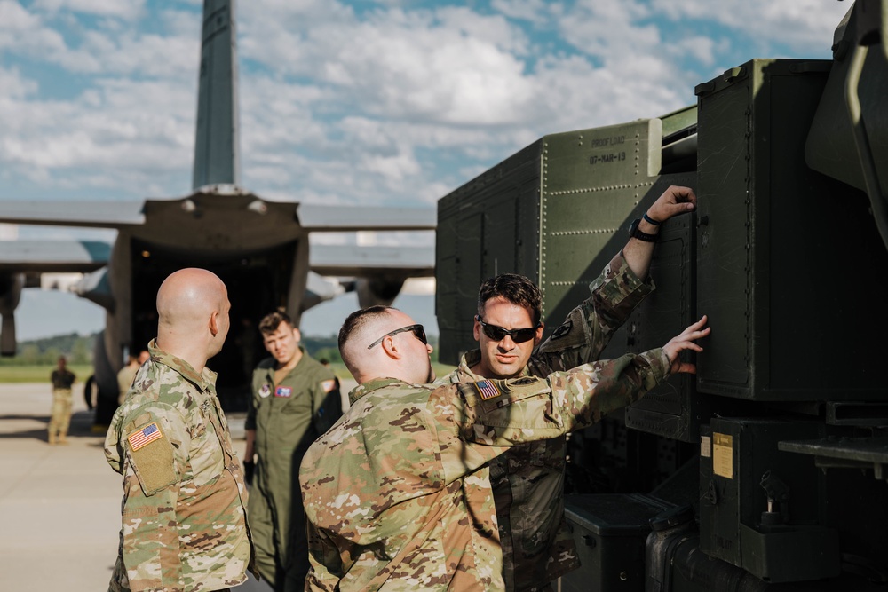 Airmen load a High Mobility Artillery Rocket System onto a C-130 Hercules