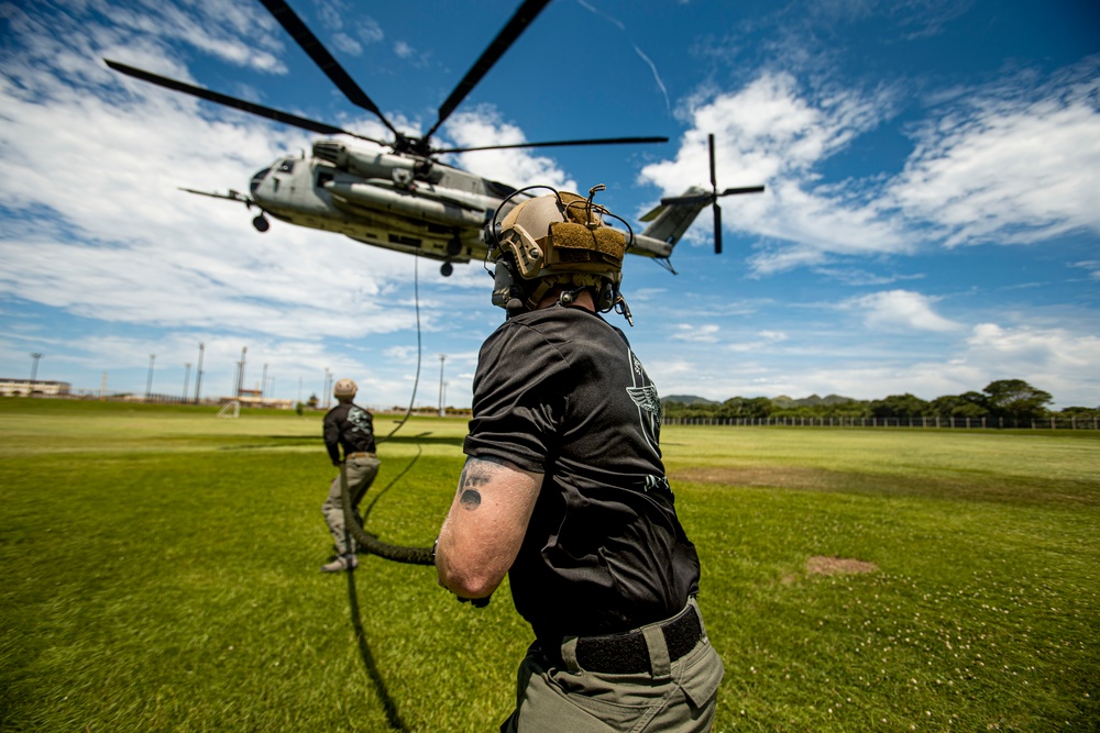 US Marines with Maritime Raid Force fast rope off a CH-53E Super Stallion and UH-1Y Venom Helicopter