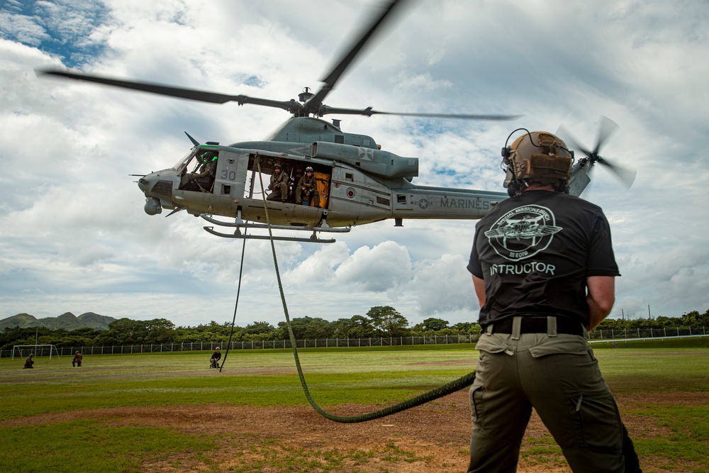 US Marines with Maritime Raid Force fast rope off a CH-53E Super Stallion and UH-1Y Venom Helicopter