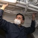Information Systems Technician 1st Class John Avestruz, from Fairfield, Calif., installs an ethernet cord