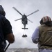 Sailors aboard USS Rafael Peralta (DDG 115) prepare to unload stores from a MH-60R Seahawk assigned to (HSM-51) during a vertical replenishment with USNS Pecos (T-AO-197)