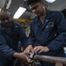 Damage Controlman 1st Class Jacob Lighten (left), from St. Louis, Mo., demonstrates how to apply a jubilee patch with Gas Turbine Systems Technician Fireman Emerico Veluz (right), from Reading, Pa.