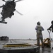 Sailors aboard USS Rafael Peralta (DDG 115) prepare to unload stores from a MH-60R Seahawk assigned to (HSM-51) during a vertical replenishment with USNS Pecos (T-AO-197)