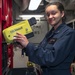 Damage Controlman 3rd Class Lareesa Garza, from Fayetteville, N.C., inspects a Naval Firefighter Thermal Imager (NFFTI) during routine maintenance