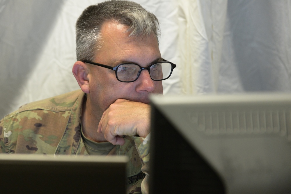 38th Infantry Division soldiers man their battle stations for 35th Infantry Division warfighter exercise