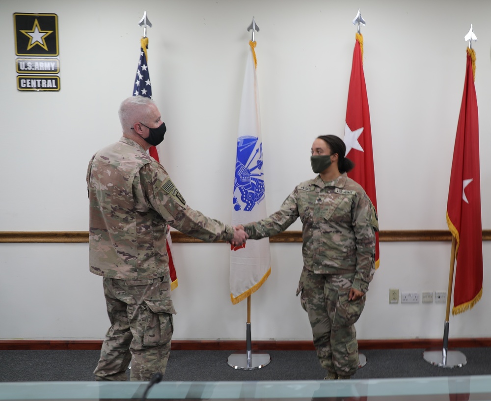 Soldier receives coin and certificate of appreciation as part of the SHARP program recognition