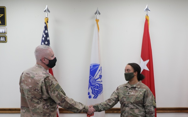 Soldier receives coin and certificate of appreciation as part of the SHARP program recognition