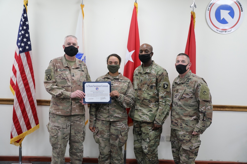 Soldier receives coin and certificate of appreciation as part of the SHARP program recognition