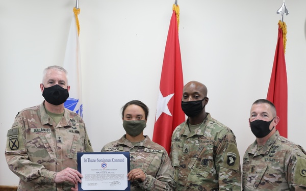Soldier receives coin and certificate of appreciation as part of the SHARP program recognition