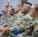 Soldiers with the 318th Chemical Biological Radiological and Nuclear Defense Company receive coins and combat patches for their time in Jordan