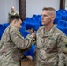 Soldiers with the 318th Chemical Biological Radiological and Nuclear Defense Company receive coins and combat patches for their time in Jordan