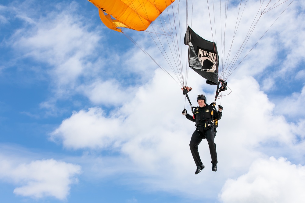 Parachutist displays POW/ MIA flag