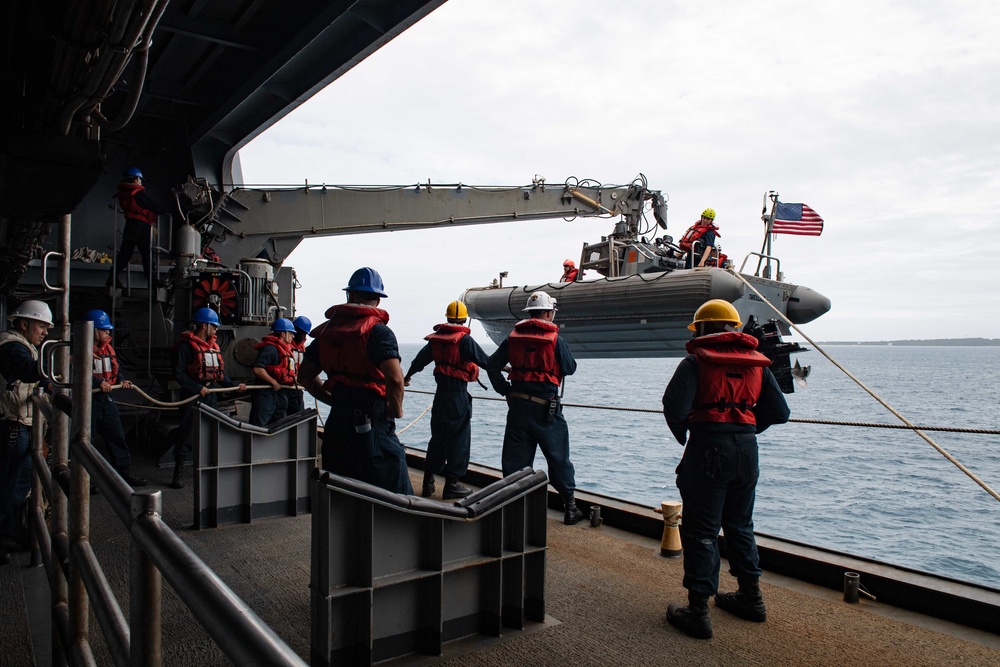 Sailors assigned to USS New Orleans (LPD 18) lower a rigid hull inflatable boat into the sea