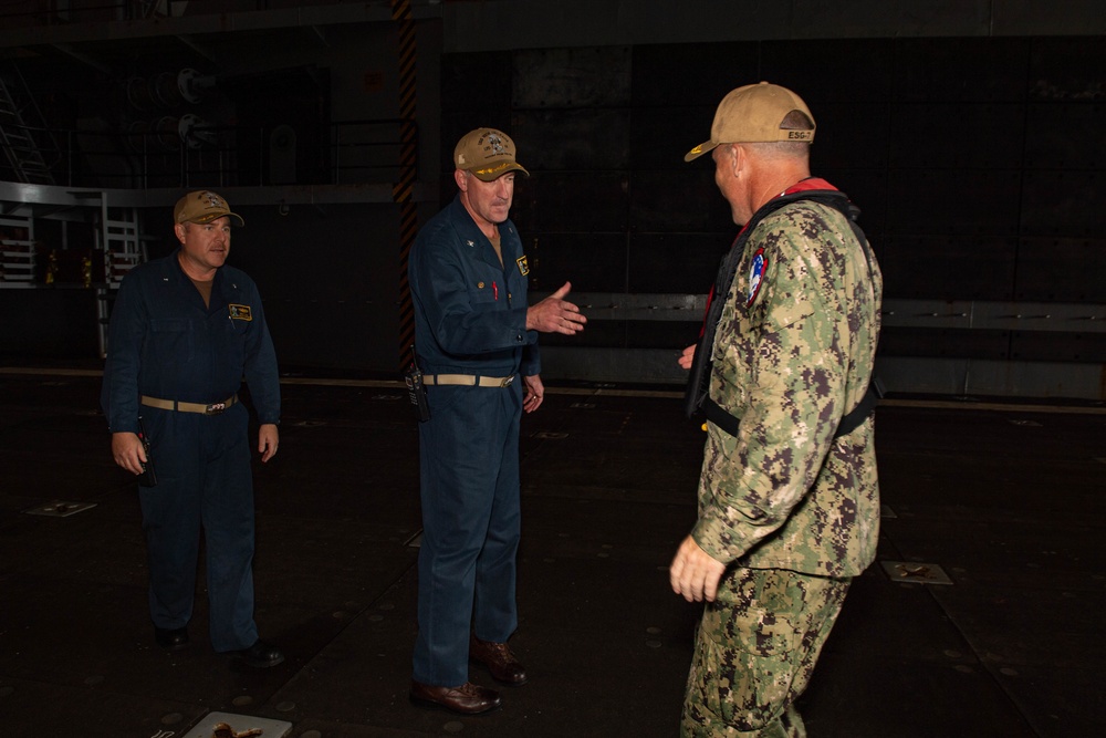 Rear Adm. Christopher Engdahl, commander, Expeditionary Strike Group 7/Task Force 76 greets Capt. Brian Schrum, commanding officer of USS New Orleans