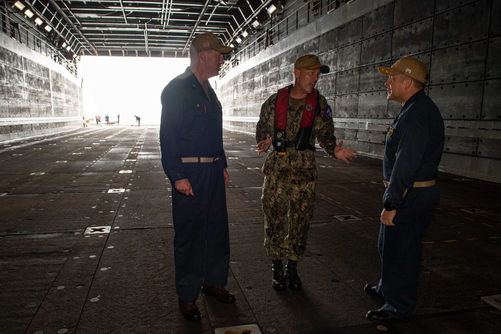 Rear Adm. Christopher Engdahl, commander, Expeditionary Strike Group 7/Task Force 76 greets Cdr. Kenneth Zilka, executive officer of USS New Orleans