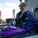 USS Sioux City Sailor Conducts Maintenance on Float Coats