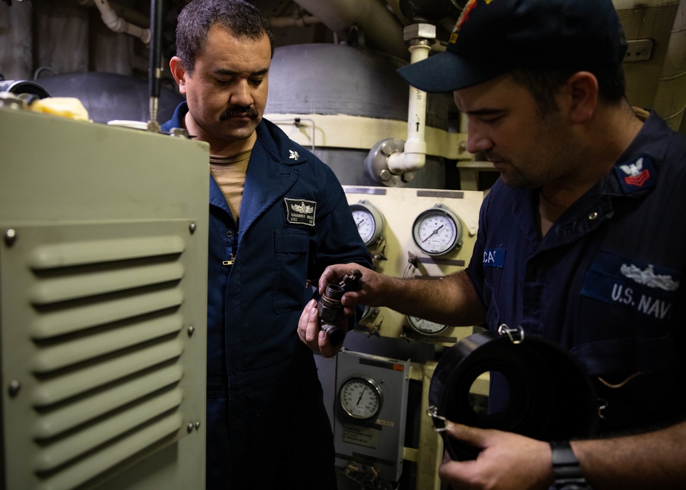 USS Sioux City Sailors Conduct Maintenance on Machinery While in Port