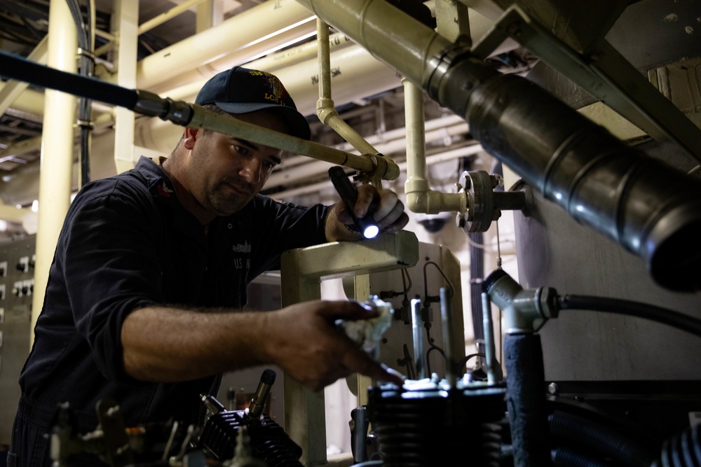 USS Sioux City Sailor Conducts Maintenance on Machinery While in Port