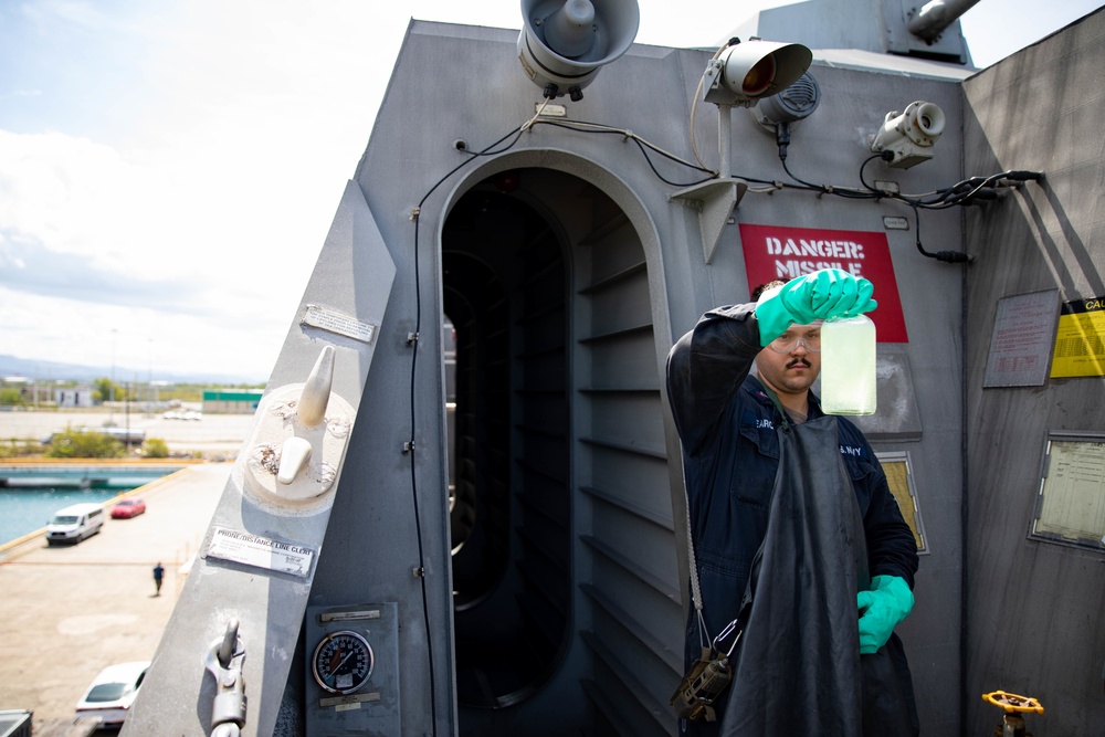 USS Sioux City Sailor Collects a Fuel Sample During a Refueling