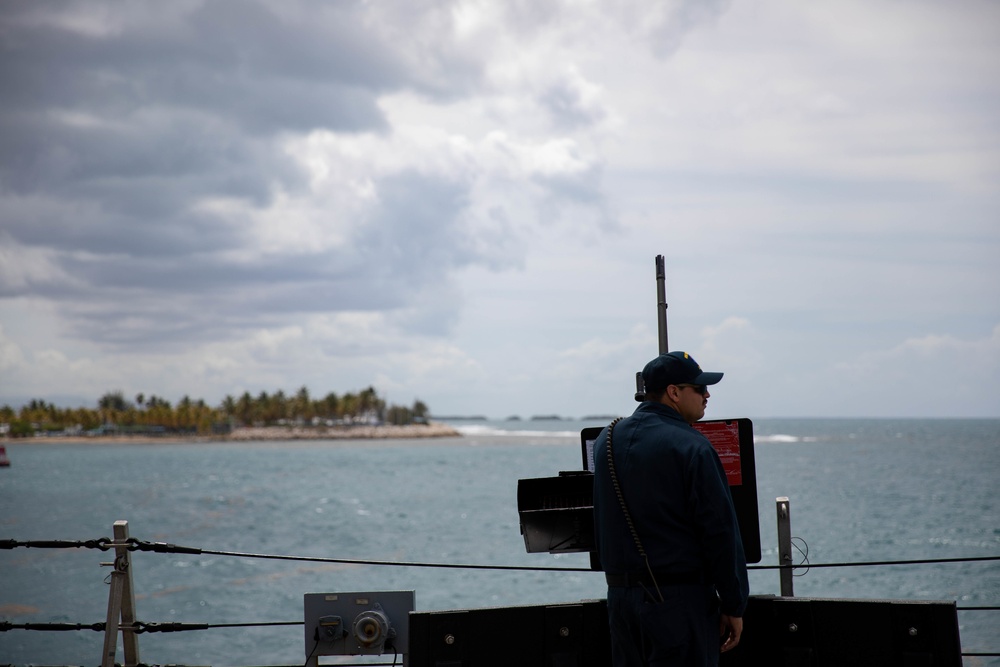 USS Sioux City Sailor Mans a .50-Caliber Machine Gun as the Ship Departs Puerto Rico