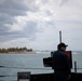 USS Sioux City Sailor Mans a .50-Caliber Machine Gun as the Ship Departs Puerto Rico