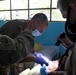 U.S. military medical professionals provide emergency care during RS-21