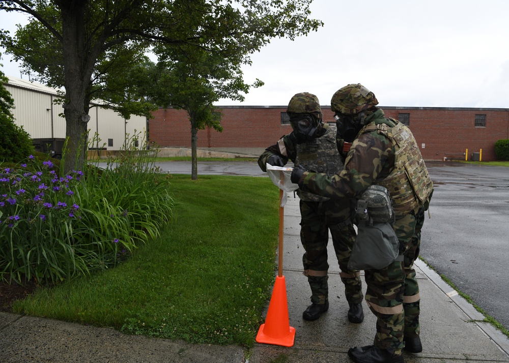 104th Fighter Wing holds Readiness Exercise, Airmen check for chemical agents after a simulated attack