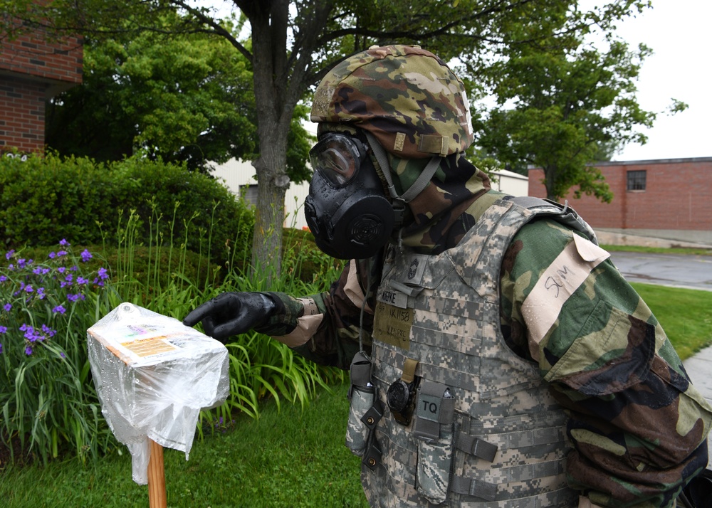 104th Fighter Wing holds Readiness Exercise, Airmen check for chemical agents after a simulated attack