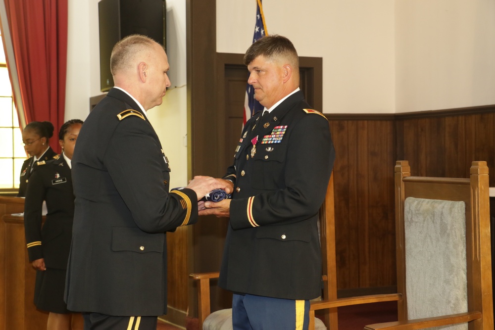 Commanding General Dwayne Wilson presents American flag