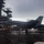USS Ronald Reagan Conducts Flight Operations in the South China Sea A U.S. Navy carrier-based jet aircraft, appearing to be an F/A-18 Hornet or Super Hornet with modex number '301' visible, is positioned on a wet aircraft carrier flight deck under overcast skies. The carrier's island superstructure, including radar domes and communication equipment, is visible on the left side of the frame. The image has motion blur suggesting either camera movement or the aircraft taxiing.