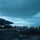 USS Ronald Reagan Conducts Flight Operations in the South China Sea The image shows the flight deck of a United States Navy aircraft carrier during overcast, low-light conditions, likely at dusk or dawn. Multiple jet aircraft, identifiable as F/A-18 Hornets or Super Hornets, are parked and staged along the deck. Deck crew personnel are visible moving among the aircraft in the background.