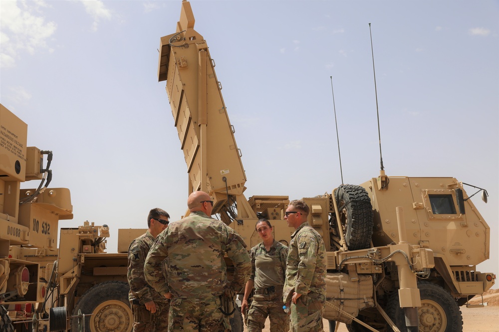 Members of the Target Acquisition Platoon, 130th Field Artillery Brigade, beside the AN/TPQ-53 radar