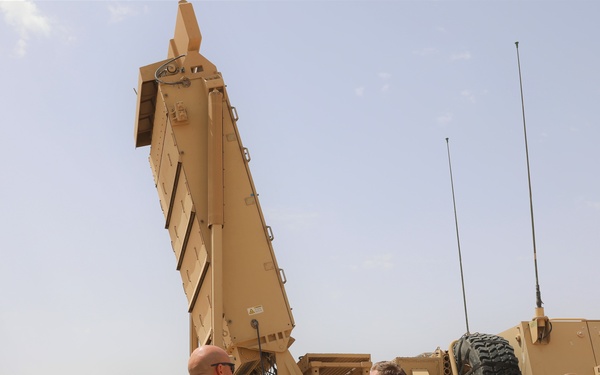 Members of the Target Acquisition Platoon, 130th Field Artillery Brigade, beside the AN/TPQ-53 radar