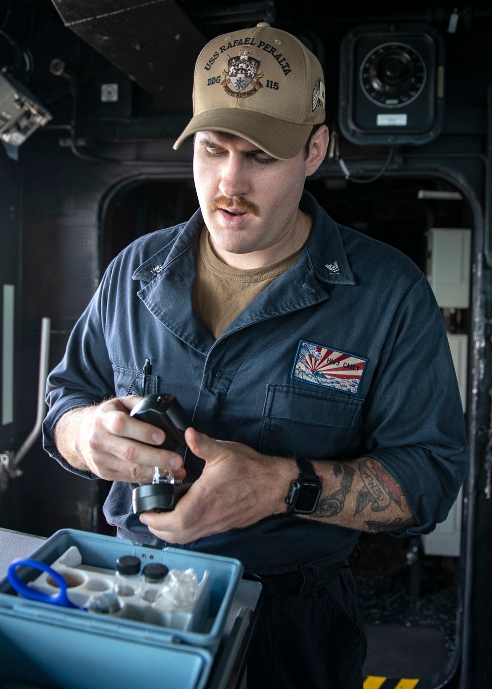 Hospital Corpsman 3rd Class Malcolm Carey conducts a water safety test in the pilot house