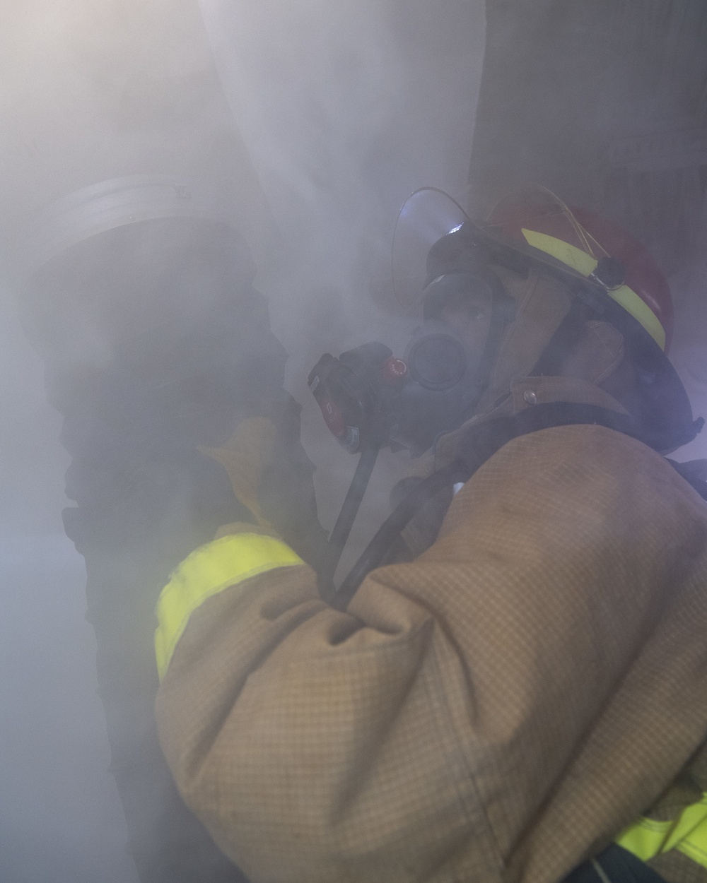 Sailor uses a RAMFAN to desmoke a space during a firefighting drill