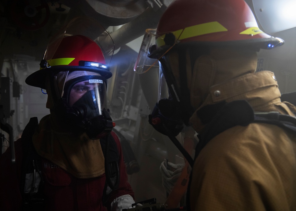 Sailors report casualty information during a firefighting drill