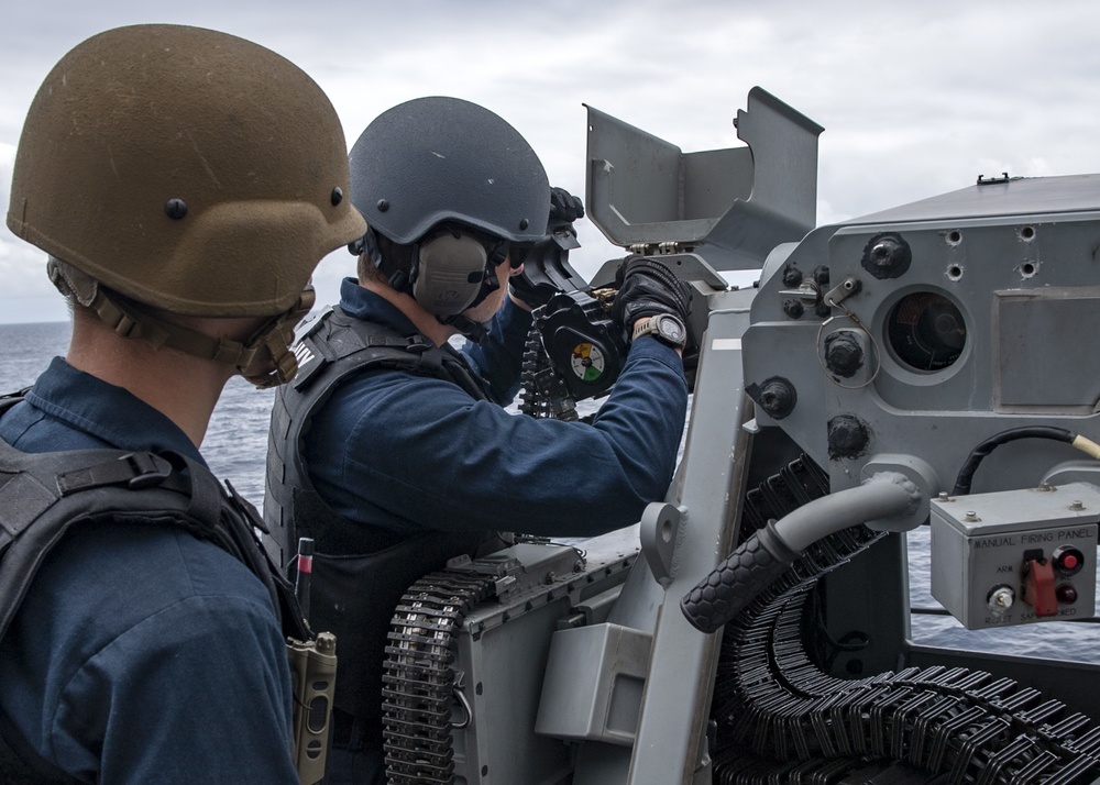 Gunner’s Mate 2nd Class Robert Rice (right), from Rome, N.Y., demonstrates how to load a Mk 52 Mod 0 Coax machine gun for Seaman Aidan Crowley (left), from Salt Lake City, Utah, during a live-fire exercise