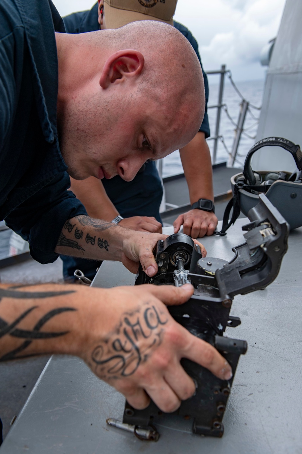 Gunner’s Mate Seaman Class Anthony Adino, from Brooklyn, N.Y., configures a Mk 52 Mod 0 Coax machine gun