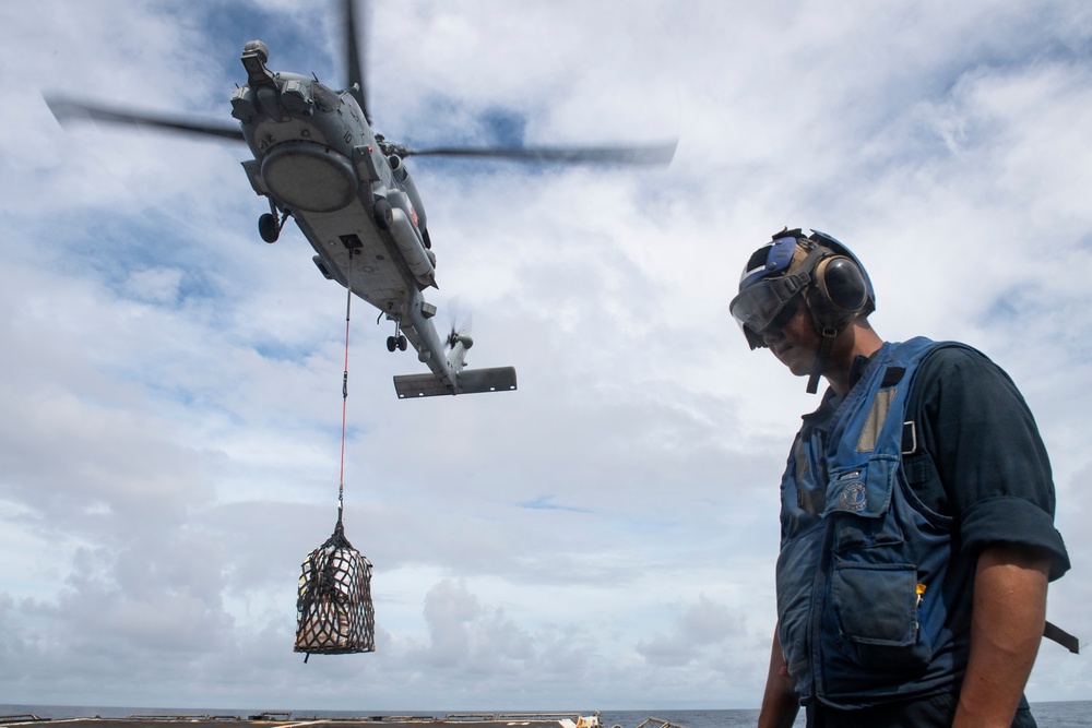 A Sailor prepares to unload stores from a MH-60R Seahawk assigned to the “Warlords” of Helicopter Maritime Strike Squadron (HSM-51)