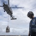 A Sailor prepares to unload stores from a MH-60R Seahawk assigned to the “Warlords” of Helicopter Maritime Strike Squadron (HSM-51)